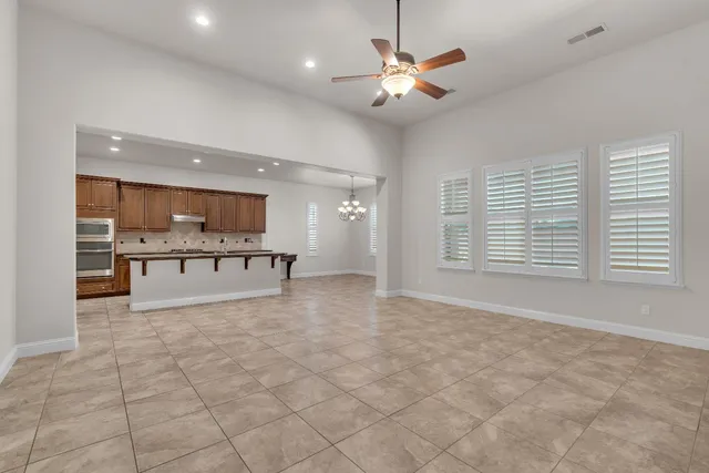 a view of kitchen with stove and cabinets