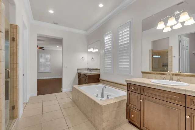 a spacious bathroom with a granite countertop sink mirror and bathtub