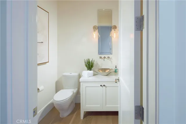 a bathroom with a sink a toilet and mirror