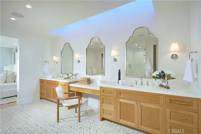 a spacious bathroom with a double vanity sink and a mirror