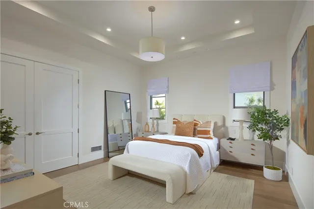 a bedroom with bed and a chandelier