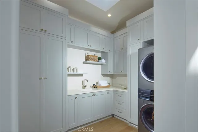 a room with white cabinets and sink