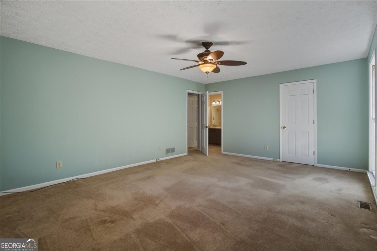 590 South New Salem Road Griffin, GA 30223 - Photo 21 of 52 an empty room with a window and a ceiling fan