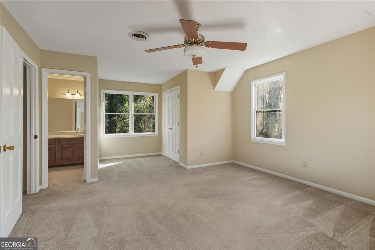 590 South New Salem Road Griffin, GA 30223 - Photo 24 of 52 an empty room with windows and fan