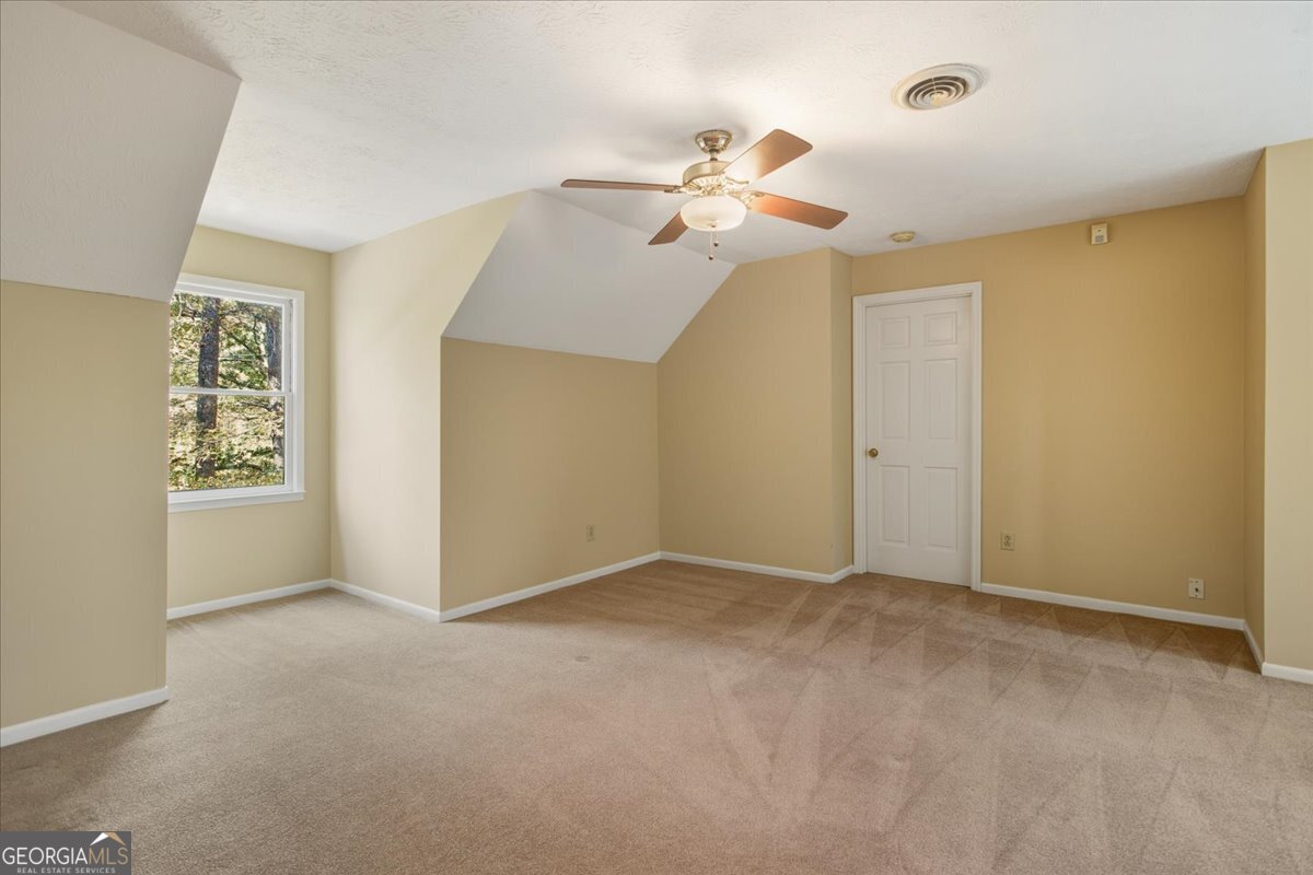 590 South New Salem Road Griffin, GA 30223 - Photo 28 of 52 a view of an empty room with window and chandelier fan