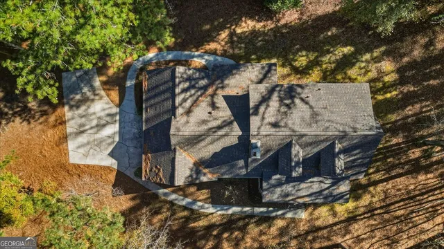 an aerial view of residential houses with outdoor space and trees