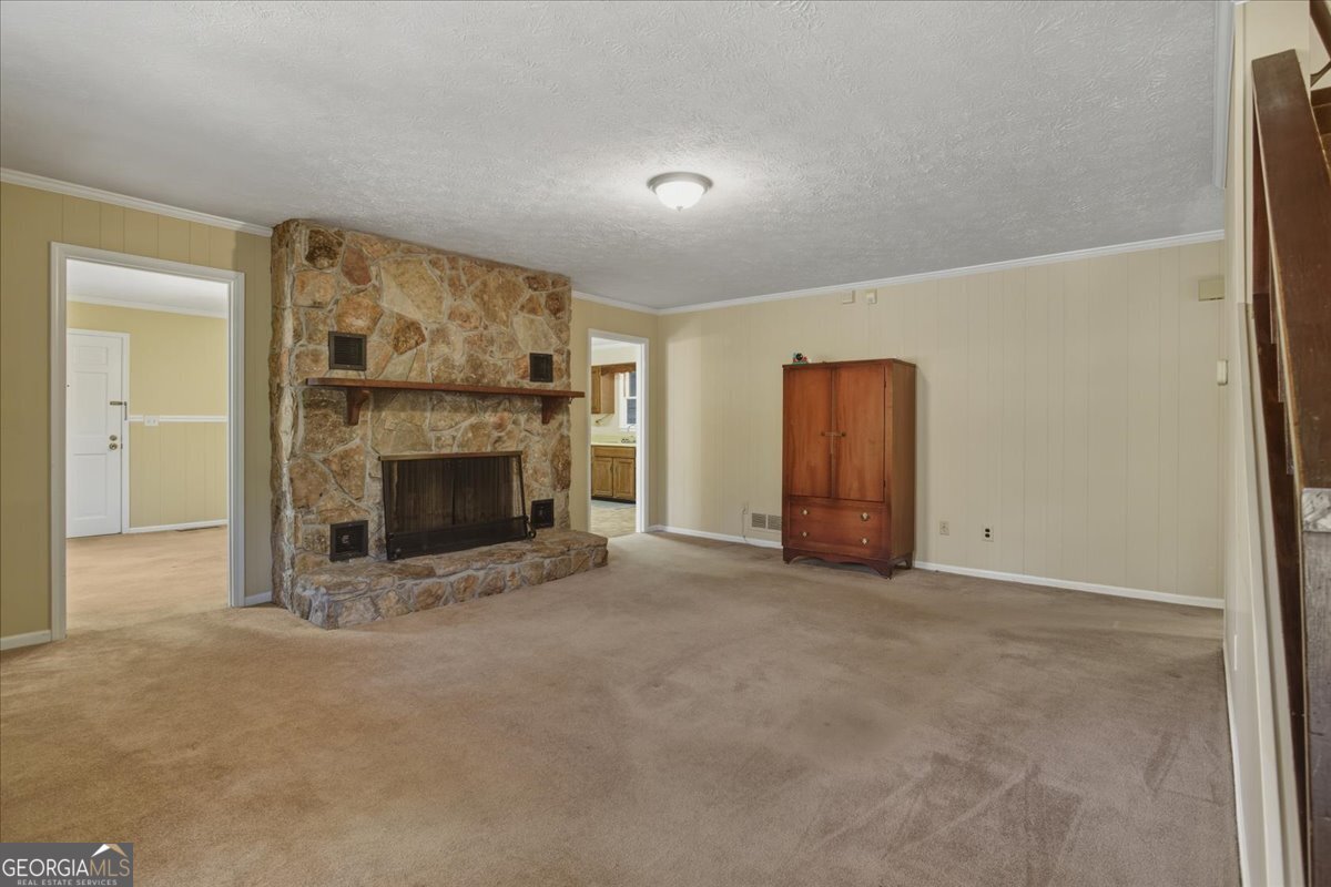 590 South New Salem Road Griffin, GA 30223 - Photo 5 of 52 an empty room with furniture and a fireplace