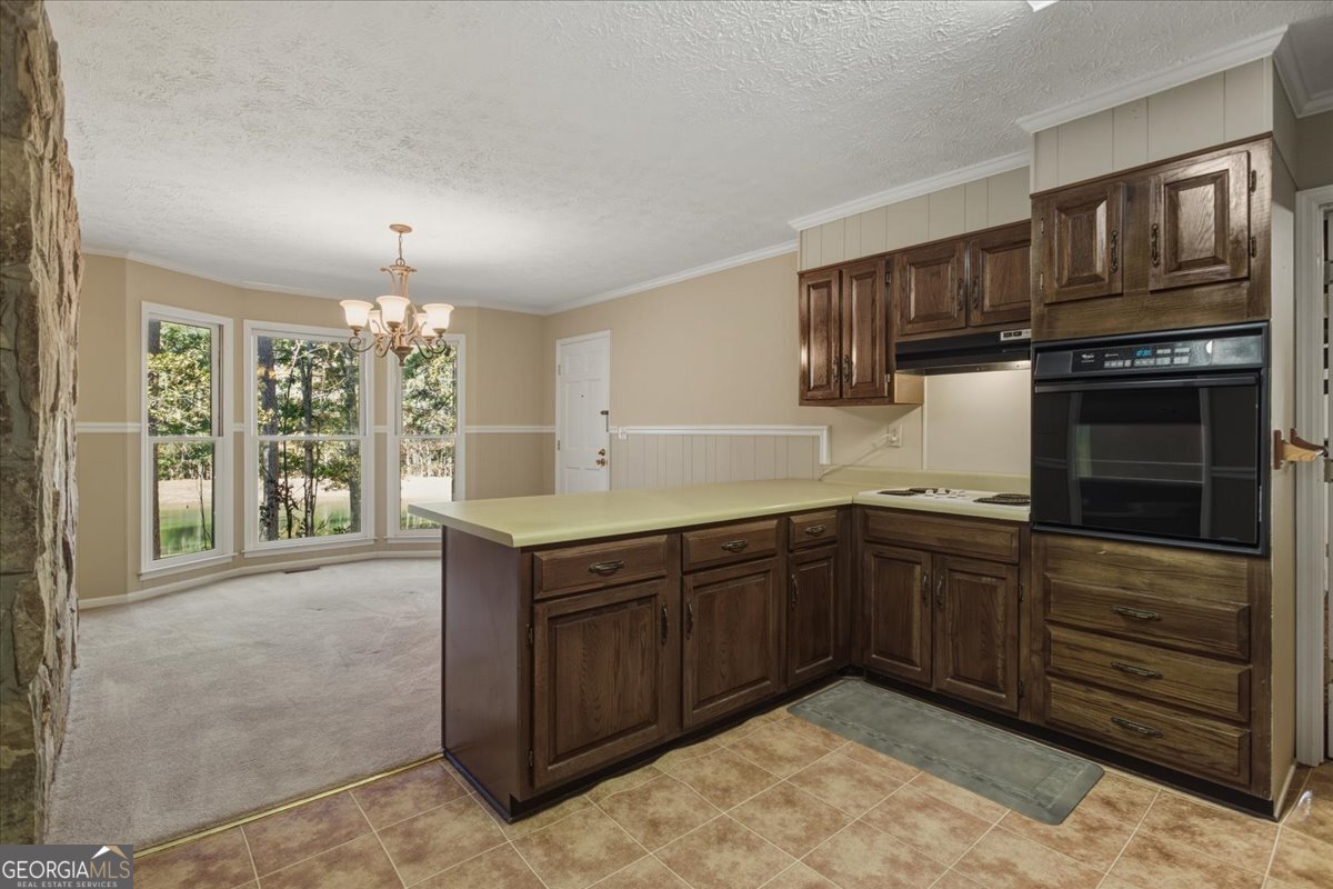 590 South New Salem Road Griffin, GA 30223 - Photo 10 of 52 a kitchen with stainless steel appliances granite countertop a stove and cabinets