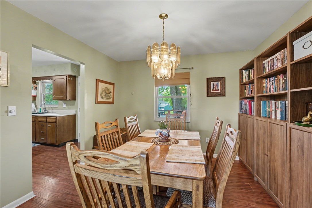 4919 Silver Arrow Drive Riverside, OH 45424 - Photo 12 of 57 This dining area features rich wood flooring, built-in shelving, and a decorative chandelier.