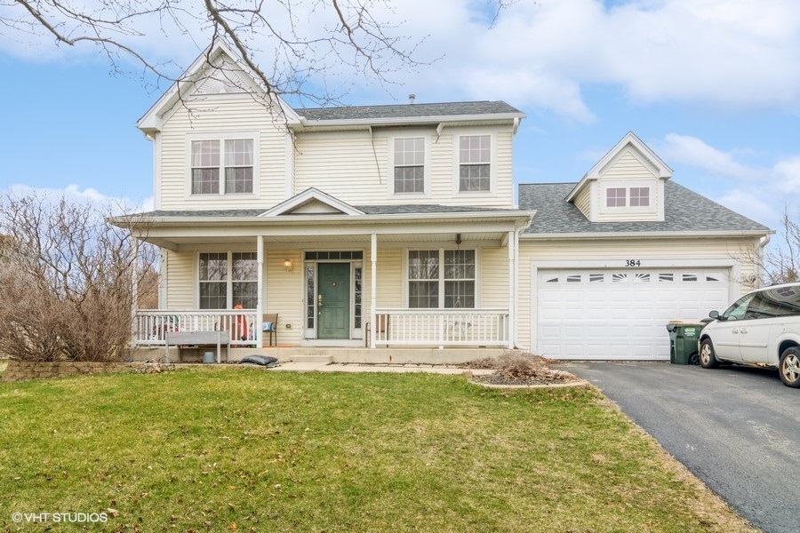 384 Kensington Drive Oswego, IL 60543 - Photo 1 of 15 a front view of a house with a garden and plants