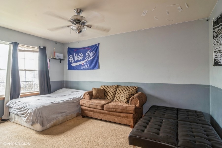 384 Kensington Drive Oswego, IL 60543 - Photo 11 of 15 a bedroom with a bed and a couch