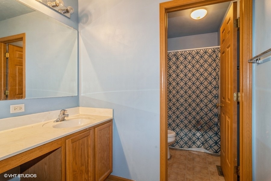 384 Kensington Drive Oswego, IL 60543 - Photo 14 of 15 a bathroom with a sink and a mirror