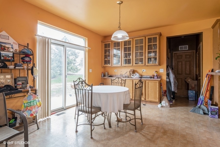 384 Kensington Drive Oswego, IL 60543 - Photo 4 of 15 a view of a dining room with furniture window and outside view