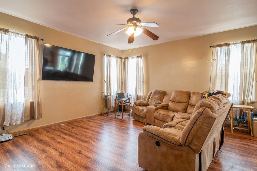 384 Kensington Drive Oswego, IL 60543 - Photo 7 of 15 a living room with furniture and a flat screen tv