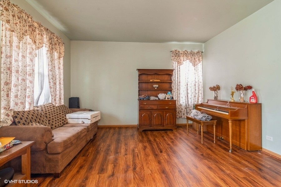 384 Kensington Drive Oswego, IL 60543 - Photo 8 of 15 a living room with furniture and a wooden floor
