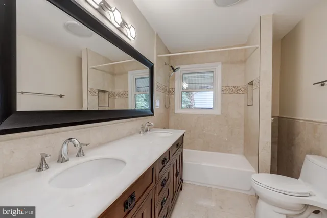 a bathroom with a sink a toilet and a bathtub