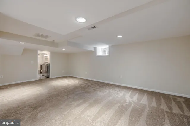 an empty room with a empty space and windows