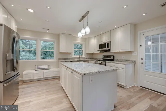 a kitchen with a stove a sink and a refrigerator