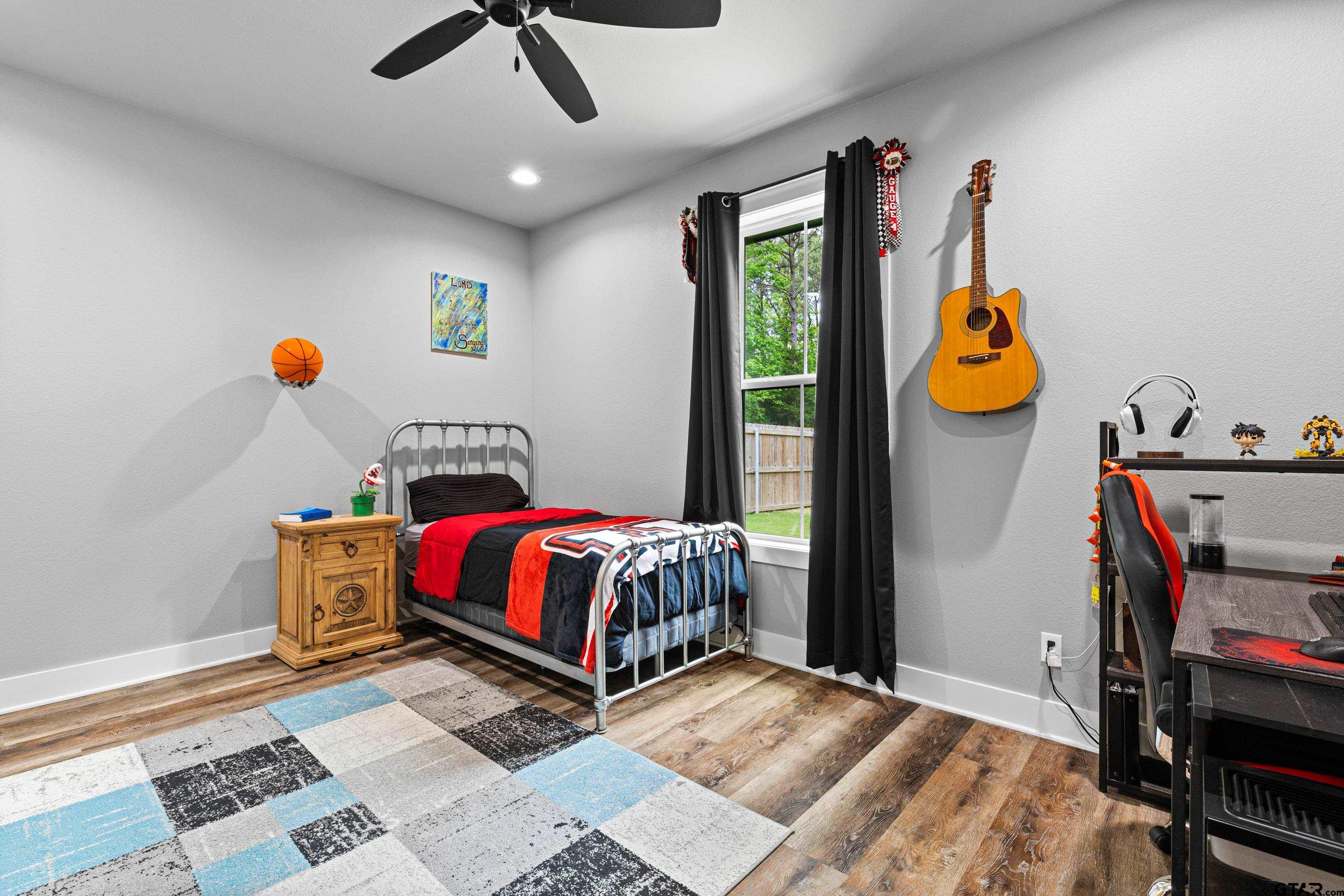 2505 Airstrip Road Gilmer, TX 75644 - Photo 16 of 37 a bedroom with a bed a dresser and window