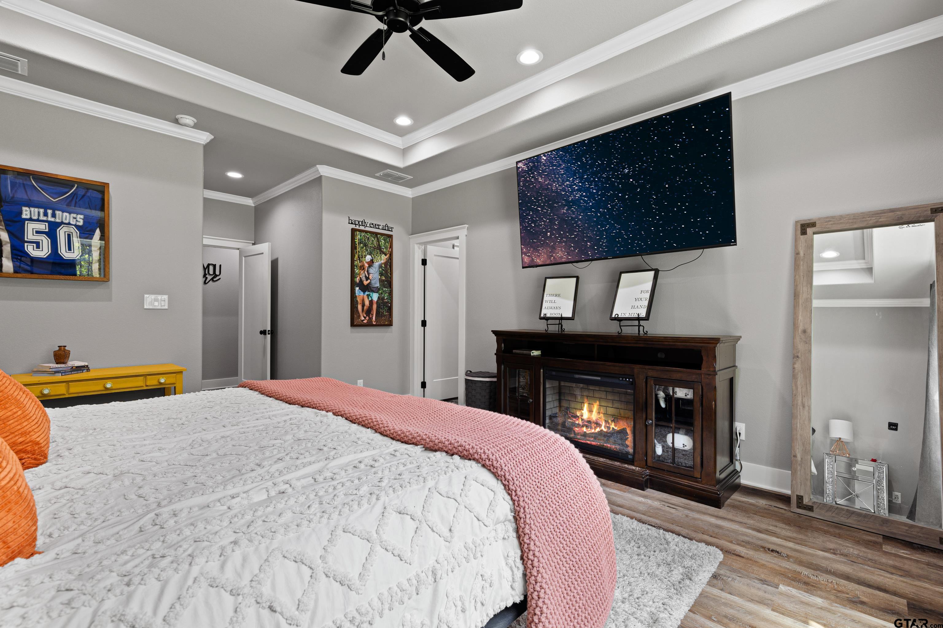 2505 Airstrip Road Gilmer, TX 75644 - Photo 19 of 37 a bedroom with a bed and a fireplace