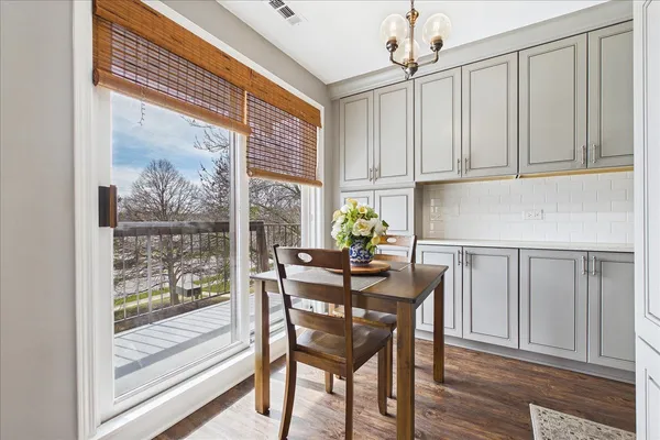 a dining room with furniture and a window