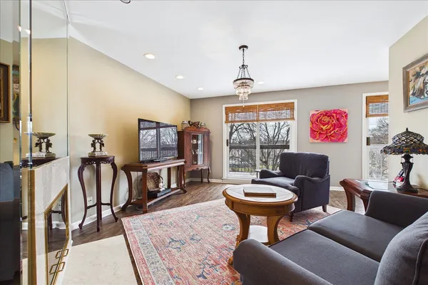 a living room with furniture a flat screen tv and a table