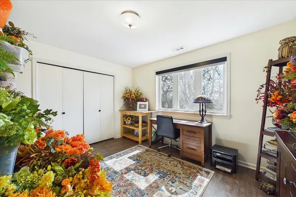a view of a workspace with furniture and a potted plant