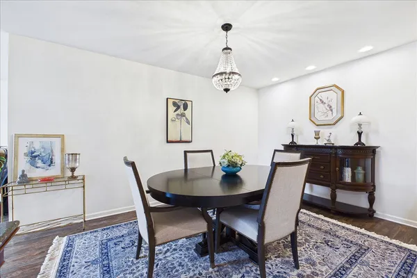 a view of a dining room with furniture and a chandelier