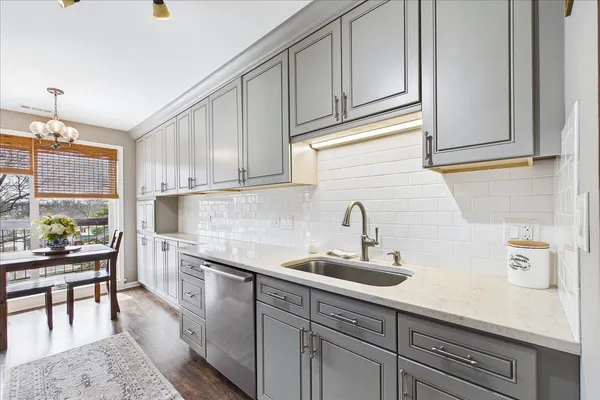 a kitchen with stainless steel appliances granite countertop a sink and cabinets