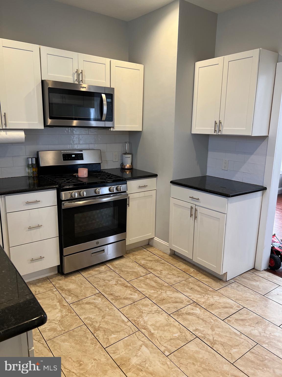 811 Laurel Road Lindenwold, NJ 08021 - Photo 8 of 29 a kitchen with stainless steel appliances a stove a microwave a sink and cabinets