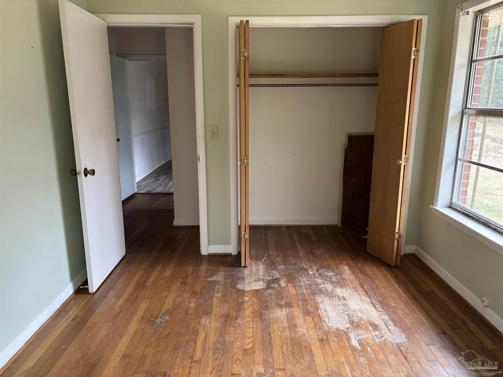 100 Brown Road McDavid, FL 32568 - Photo 13 of 20 a view of an empty room with wooden floor and a window