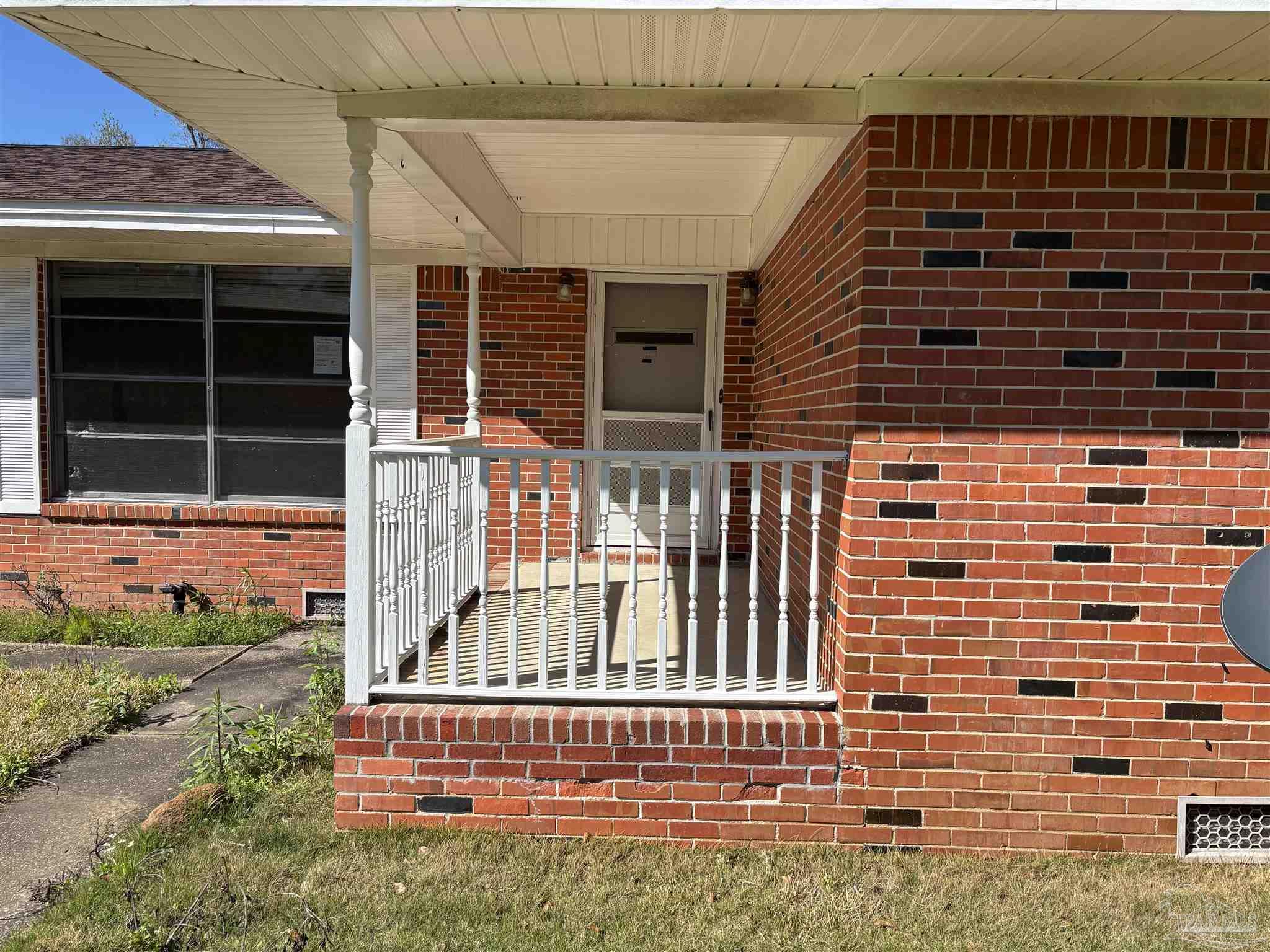 100 Brown Road McDavid, FL 32568 - Photo 2 of 20 a front view of a house with a yard