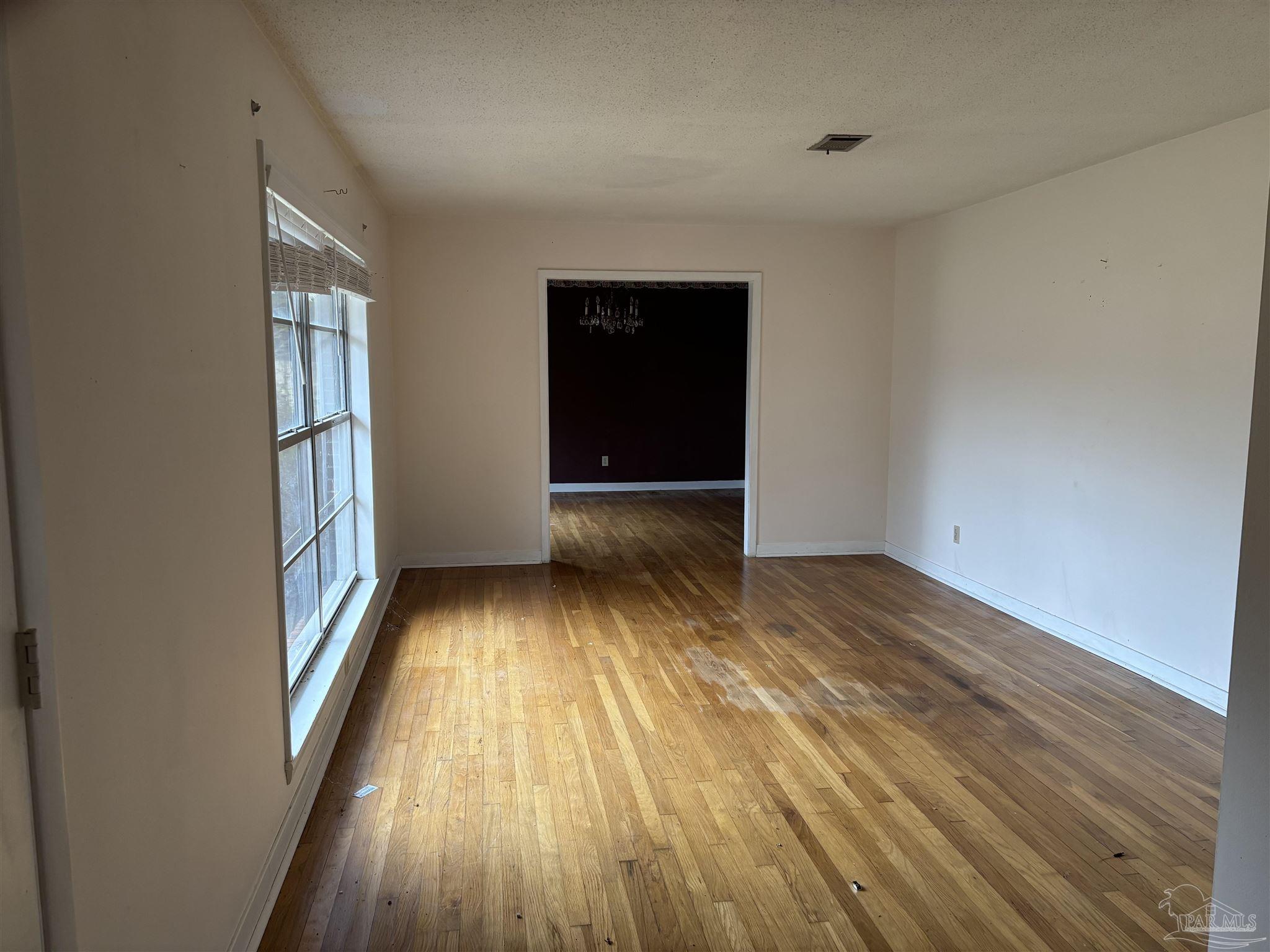 100 Brown Road McDavid, FL 32568 - Photo 3 of 20 wooden floor in an empty room with a window