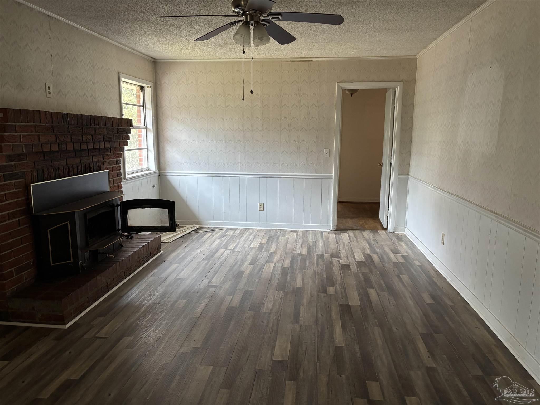 100 Brown Road McDavid, FL 32568 - Photo 7 of 20 wooden floor in an empty room with a window