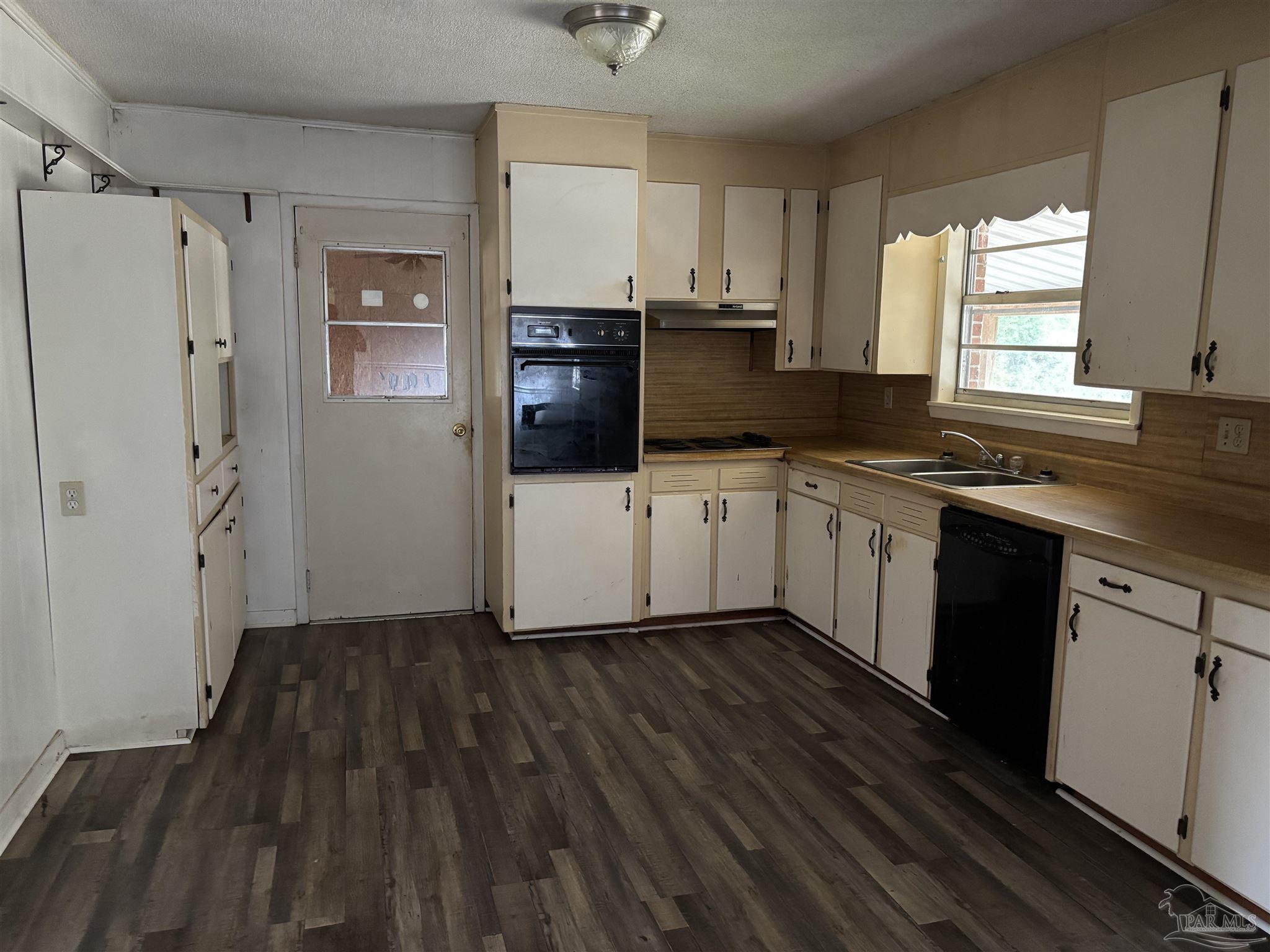 100 Brown Road McDavid, FL 32568 - Photo 8 of 20 a kitchen with a sink a refrigerator and window