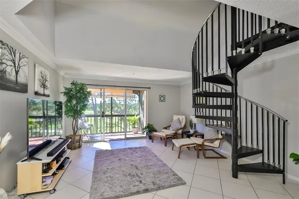 a living room with furniture and a floor to ceiling window