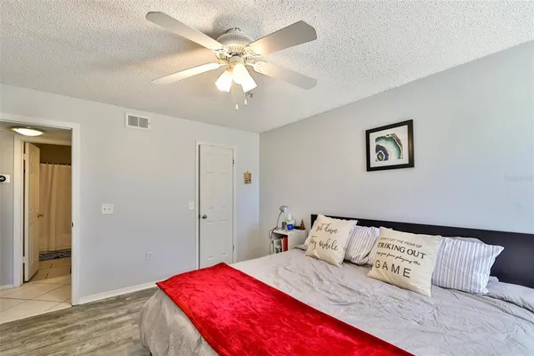 a bedroom with a large bed and a chandelier