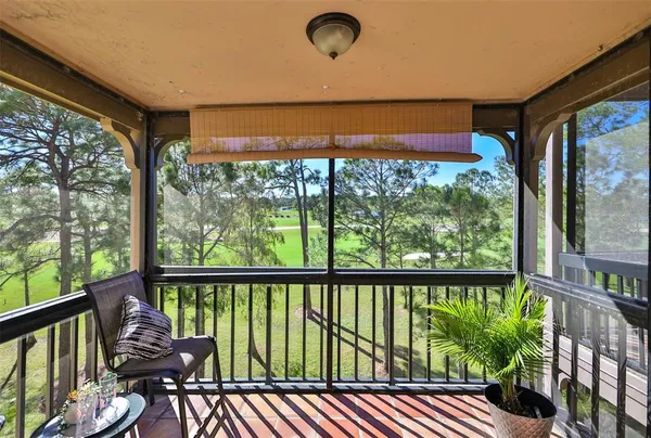 a view of a porch with furniture and wooden floor