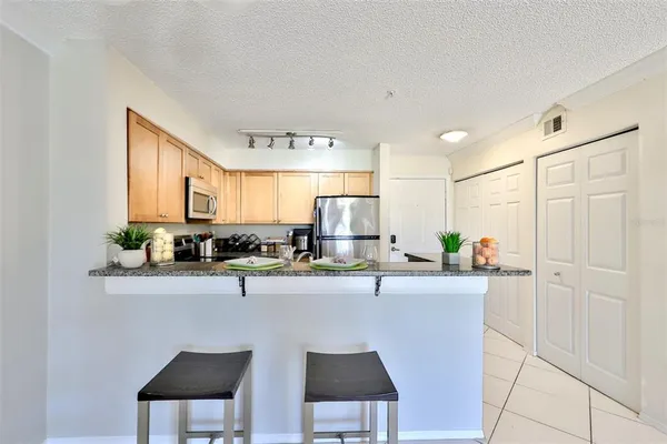 a kitchen with stainless steel appliances a sink and cabinets
