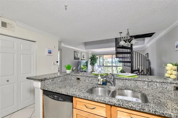 a kitchen with granite countertop a sink and a window