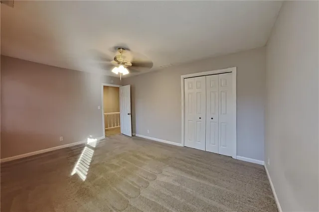 a view of a livingroom with a chandelier fan