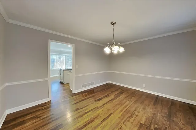 a view of a room with wooden floor and ceiling fan