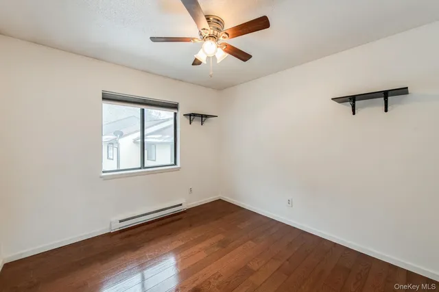 wooden floor in an empty room with a window