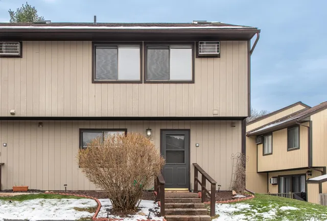 a front view of a house with stairs