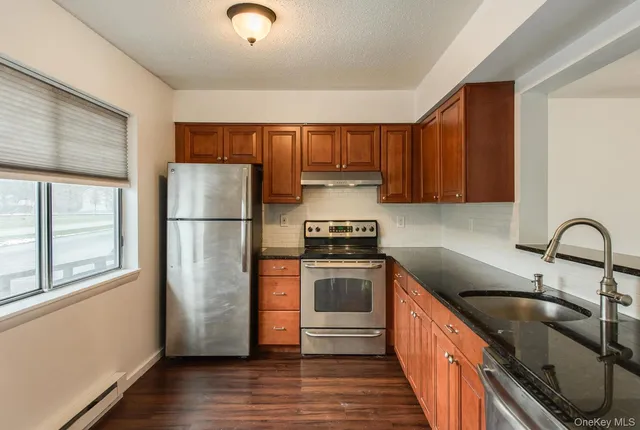 a kitchen with a refrigerator sink and cabinets