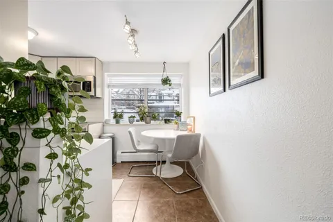 a room with table chairs and a stove