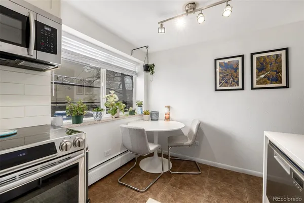 a kitchen with stainless steel appliances a sink stove and refrigerator