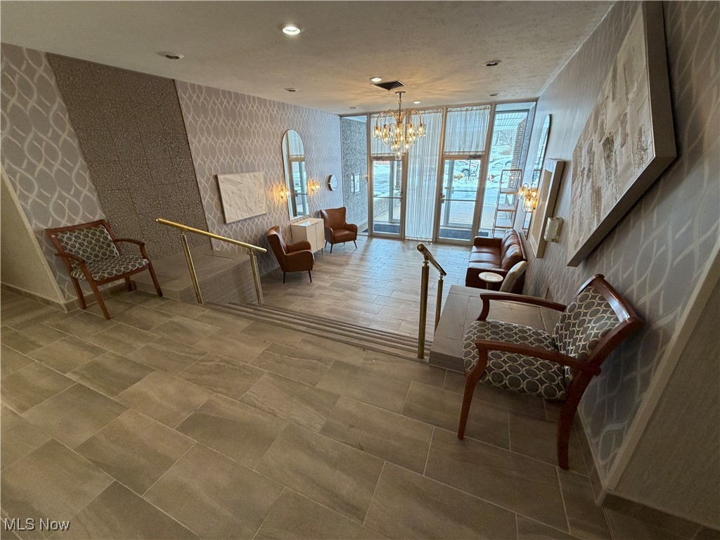3066 Kent Road, Unit 407 Stow, OH 44224 - Photo 14 of 16 Sitting room with wallpapered walls, expansive windows, a chandelier, and recessed lighting