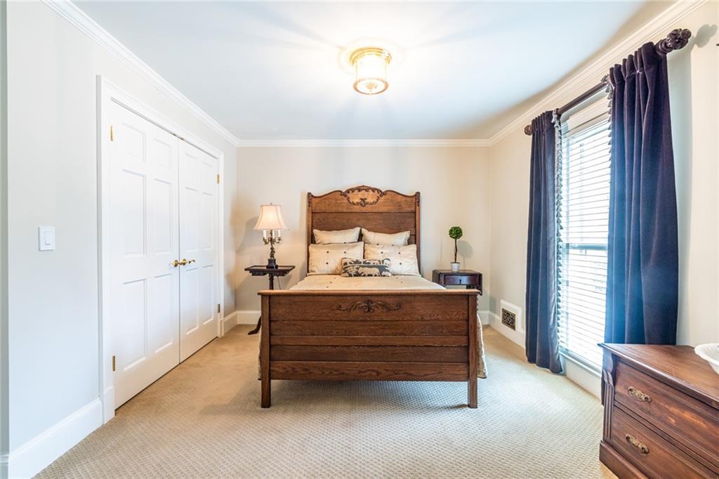 950 Heritage Hills Road Decatur, GA 30033 - Photo 51 of 88 a spacious bedroom with a bed and a chandelier