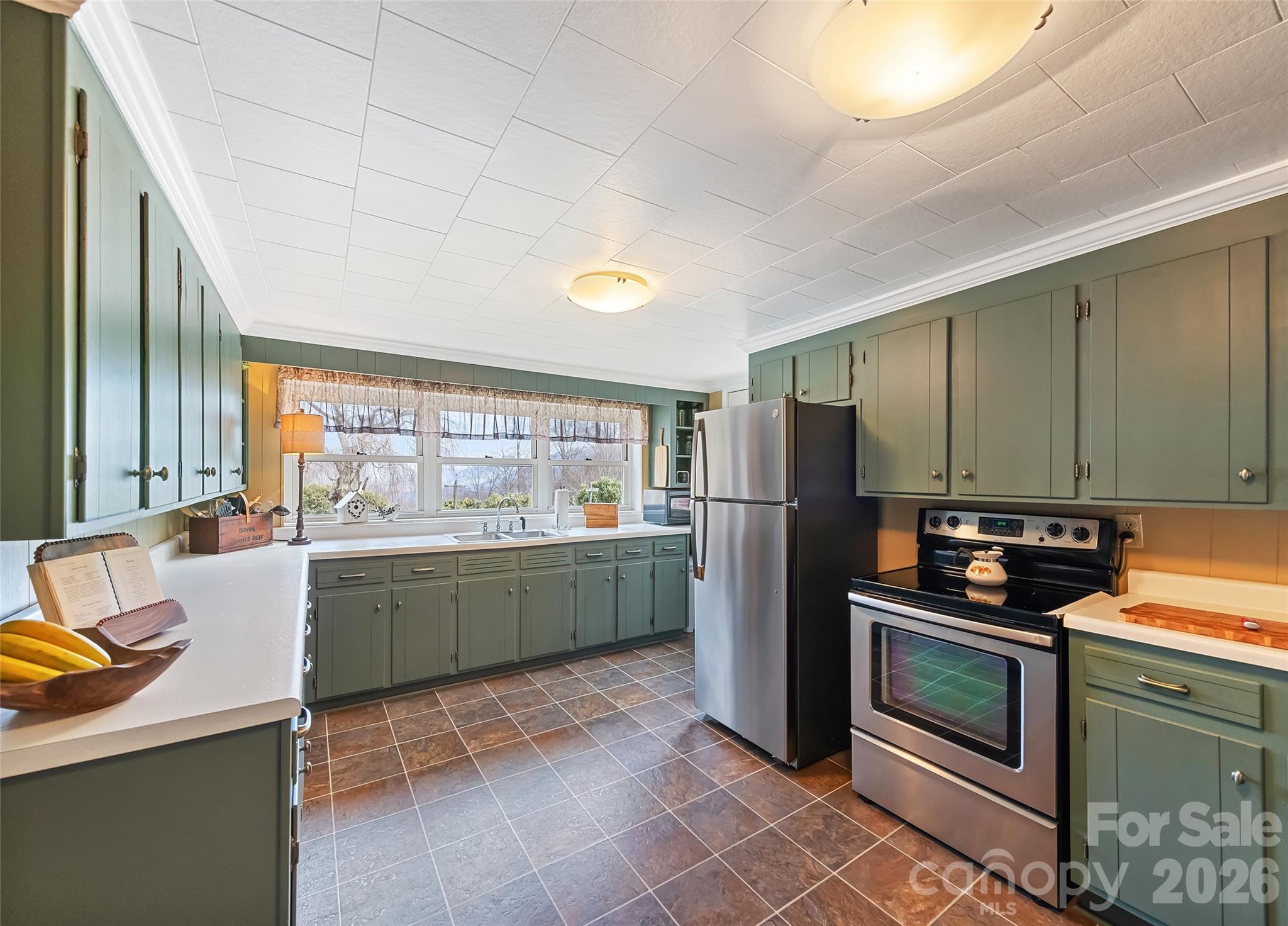 15 Whitted Road Canton, NC 28716 - Photo 11 of 38 a kitchen with stainless steel appliances kitchen island granite countertop a refrigerator stove and sink